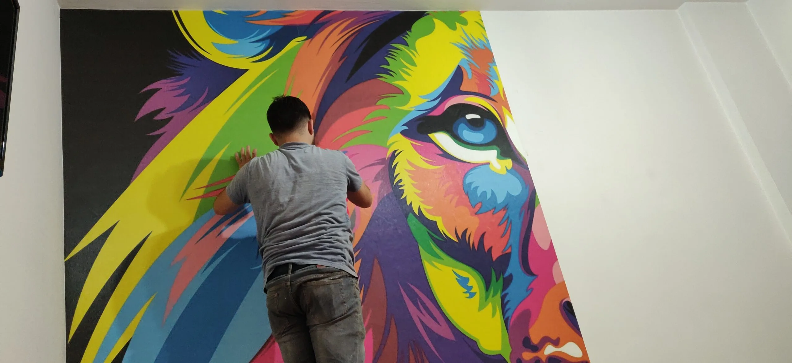 Image depicting concepts from the body and conclusion of the blog about 'Dynamic Lion Mural Brings Life to Shoreview Residence'. Wallpaper Twins’ lion mural installation in Shoreview, Minnesota, captivates and energizes the space.