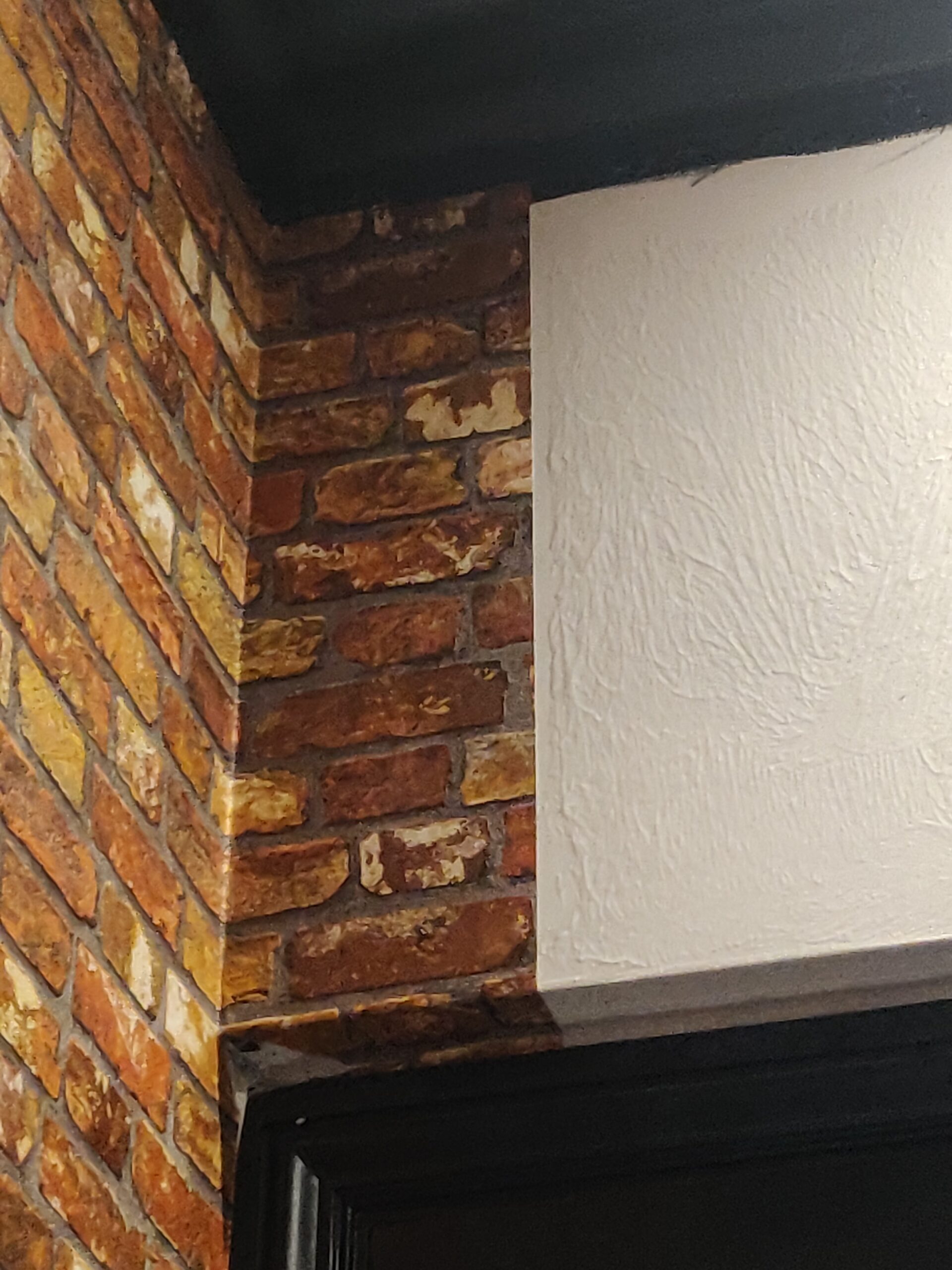 Brick pattern wallpaper in dining area.