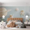 Two astronauts in a whimsical space scene with planets and stars.||