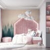Misty forest landscape with evergreen trees and soft hues of blue and peach.