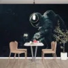Astronaut examining a white flower in outer space with a starry background.||