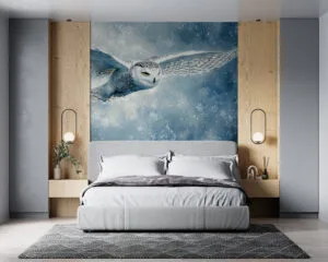 Snowy owl in flight against a wintery landscape with blues and whites