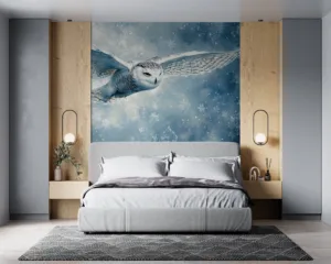 Snowy owl in flight against a wintery landscape with blues and whites||