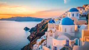 Greece with whitewashed buildings and blue domes.