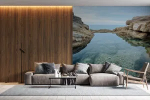 Tidal pool by the coast surrounded by rocky cliffs.