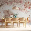 Young elephant sitting under a tree with pink blossoms in a serene environment||