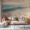 Serene beach scene at sunset with soft blues and greens of ocean waves and warm sandy beach tones.