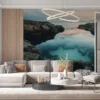 Serene coastal landscape with rocky formations and a calm body of water during sunset.||