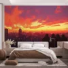 Group of four people on a rooftop overlooking a colorful urban skyline at sunset||