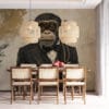 Stylized monkey in formal outfit with vintage goggles against a textured wall