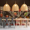 Cartoon monkeys in a theater wearing oversized glasses and enjoying popcorn and drinks.||