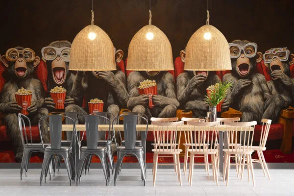Cartoon monkeys in a theater wearing oversized glasses and enjoying popcorn and drinks.
