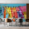 A colorful clothesline with various garments against a blue sky.||