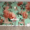 Floral design with coral flowers and green leaves on a mint background.||