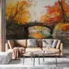 Serene autumn landscape with a bridge covered in leaves||