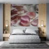 A collection of rose petals scattered on a textured surface.||