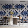 Geometric floral pattern in blue on a light background.||