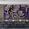 Intricate floral paper cut design in shades of purple and cream.||