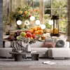 Cozy kitchen table setting with fruits and baked goods near a window||