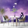 Silhouette of a person reading in a serene landscape with dreamy colors.||