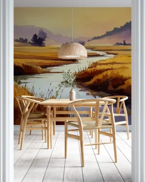 Tranquil landscape of a winding river surrounded by golden fields and rolling hills.||