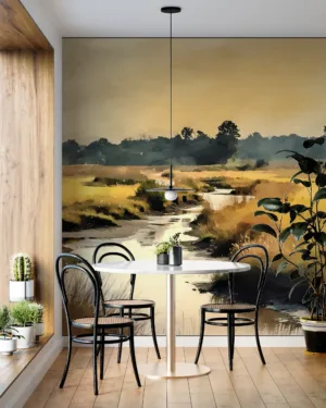 A serene natural landscape with a winding stream surrounded by grassy areas.||