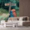 Backpack against wooden signpost in vibrant forest setting